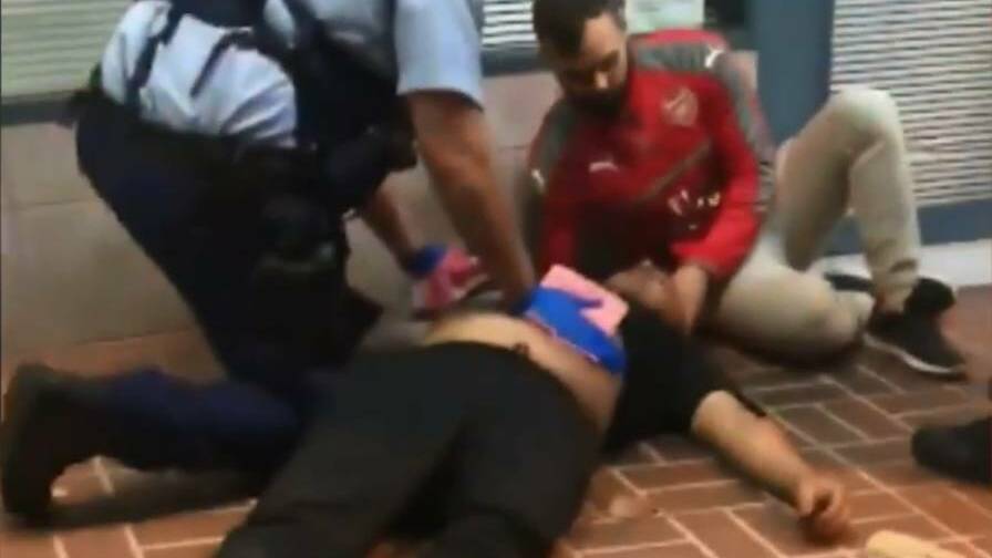 A man is treated for stab wounds outside the Arena Building in Kogarah. Picture: 9News