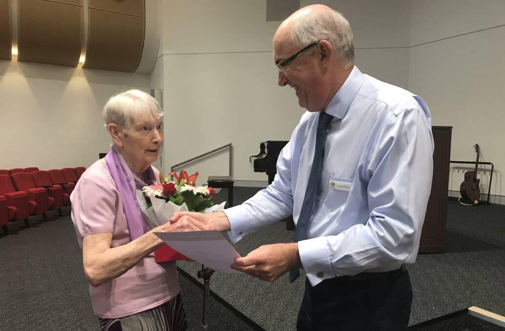 Community service: Muriel Clarke of Sylvania is thanked by Anglicare chief executive officer, Grant Millard for her 25 years of volunteering to teach English to migrants.