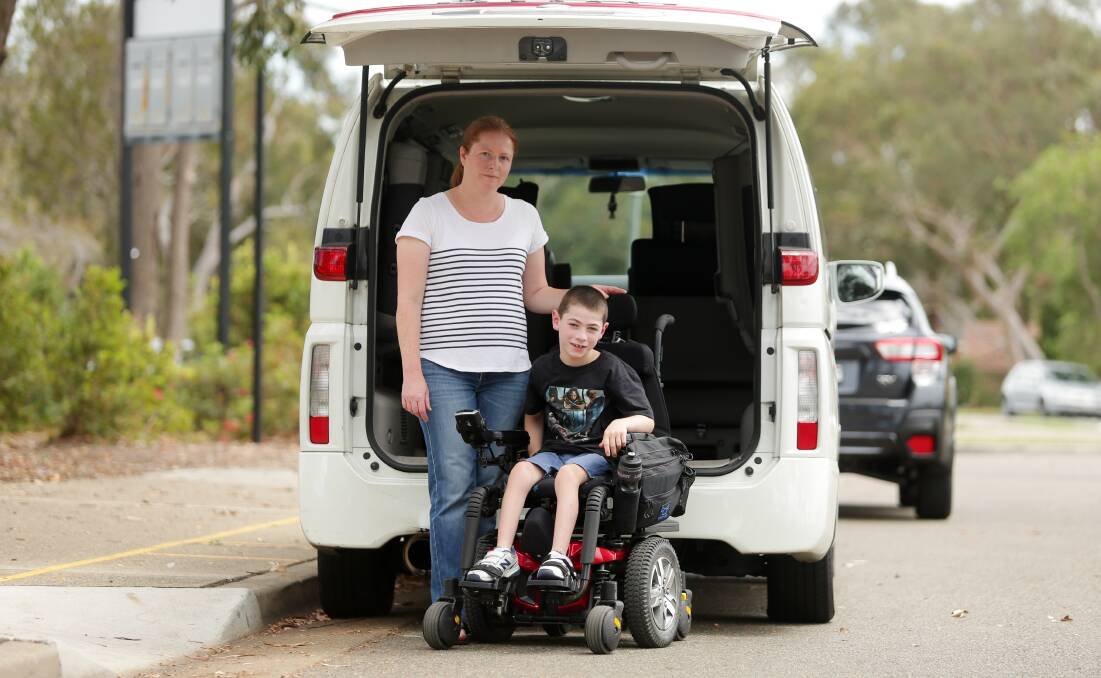 Cale with his mother, Janine, with the old family van which she had to lift him in and out.