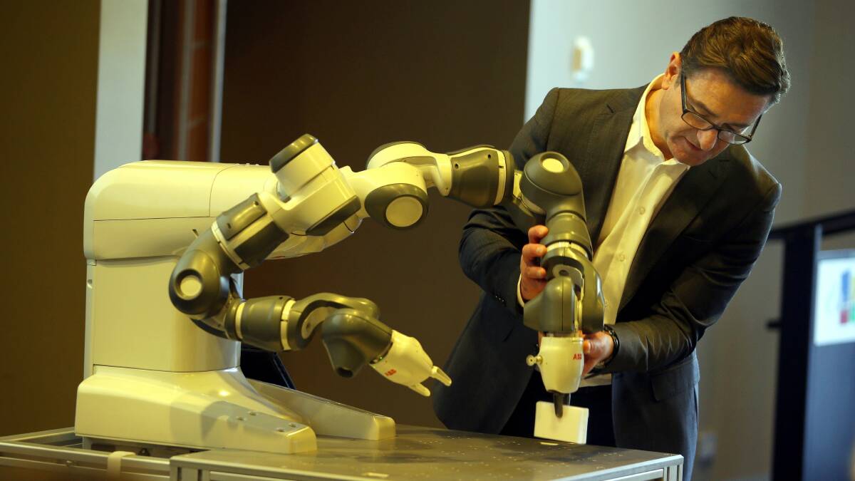 Computer says yes: ABB general manager Peter Katsos puts the YuMi robot through its motions for members of the Southern Strength Business Network. The robot has been designed to interact with humans.  Picture: John Veage