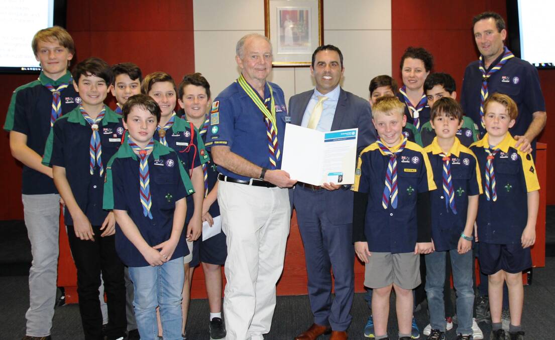 Top honour: Tony Melville, (centre) is congratulated on receiving the Silver Kangaroo Award by Sutherland Shire mayor Carmelo Pesce and members of the Ist Woronora River Scout Group.