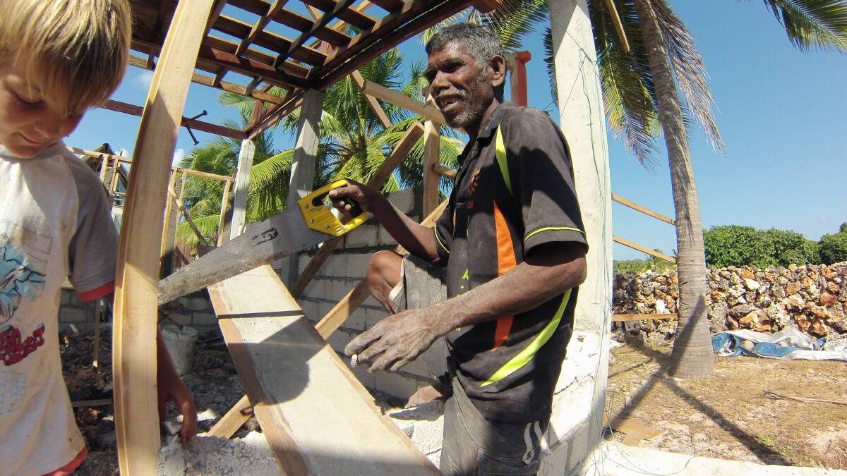 Sea change: Noah Thistlewaite helps village build the first Mercy Hut on Rote Island. Picture supplied.