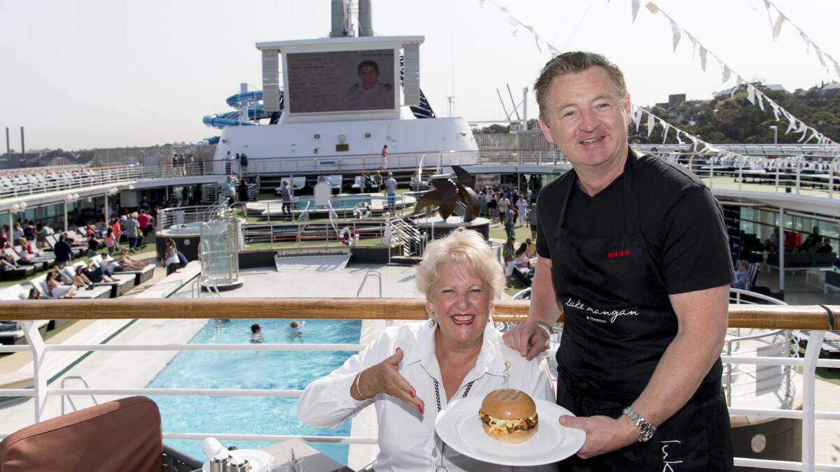 Yvonne enjoys chef Luke Mangan serving her competition-winning Japanese Fried Chicken Burger at Luke’s poolside grill on Pacific Explorer’s top deck.