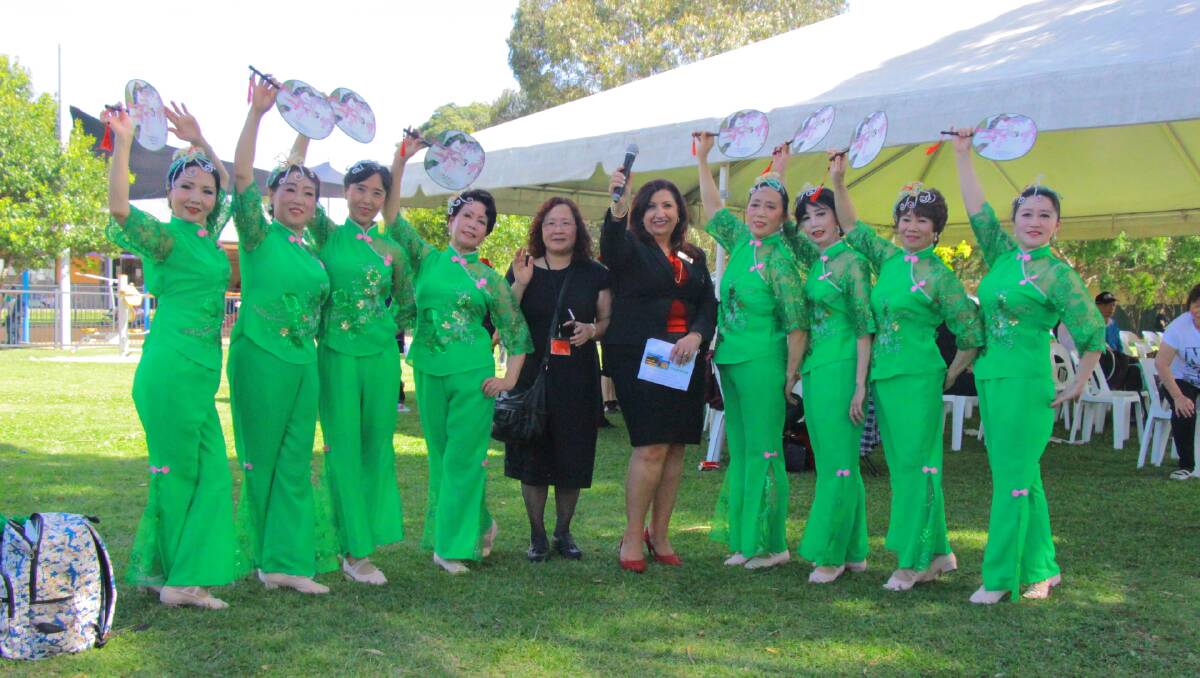 Celebration: Anne Farah Hill (centre, with micophone) with members of the Baduanjin Chinese Dancing Group, one of the performance groups at the centre’s 50th anniversary celebrations.