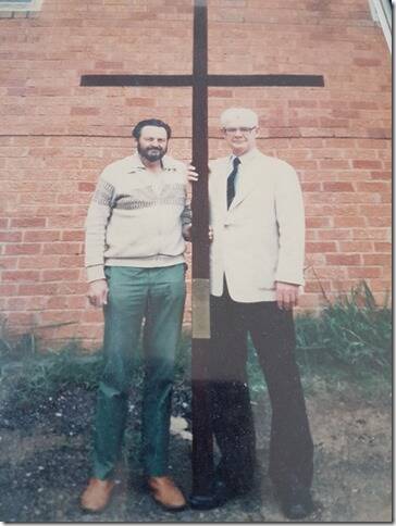 Historic moment: Ken (left) in the 1990s with the cross presented to Pope John Paul II. He is pictured with John McEwan who organised the construction of the cross with wood that came from Mary MacKillop's school.