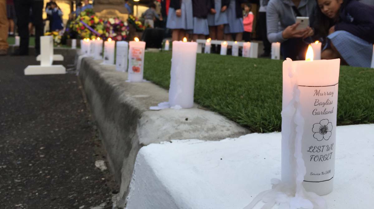 Candles lit in memory of veterans line the path to the cenotaph at Blacktown RSL. Picture: Harrison Vesey