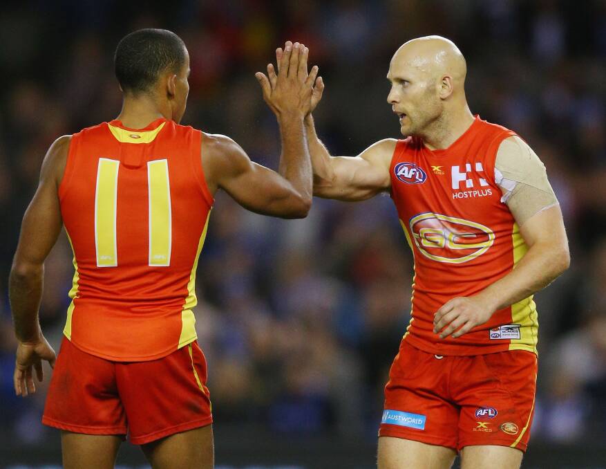 Gary Ablett of the Suns celebrates a goal with Touk Miller of the Suns (left) on Saturday night. Photo by Michael Dodge/Getty Images