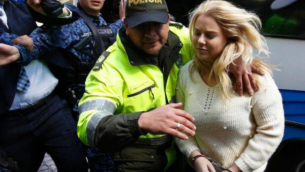 A Colombian police officer escorts Cassandra Sainsbury into court in August. Photo: AP