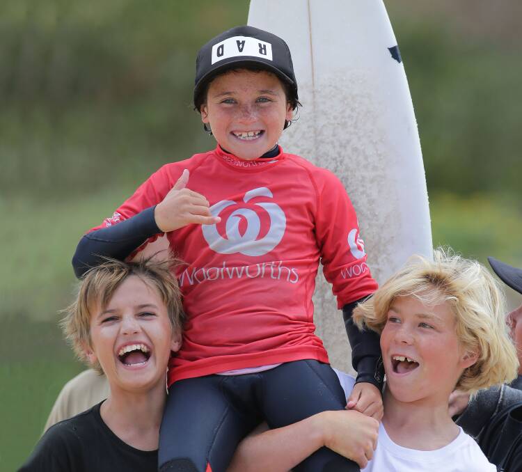 Winner,grinner: A happy Kash Brown chaired up the beach by his Cronulla Boardriders buddies after taking the u10 title. Picture: John Veage