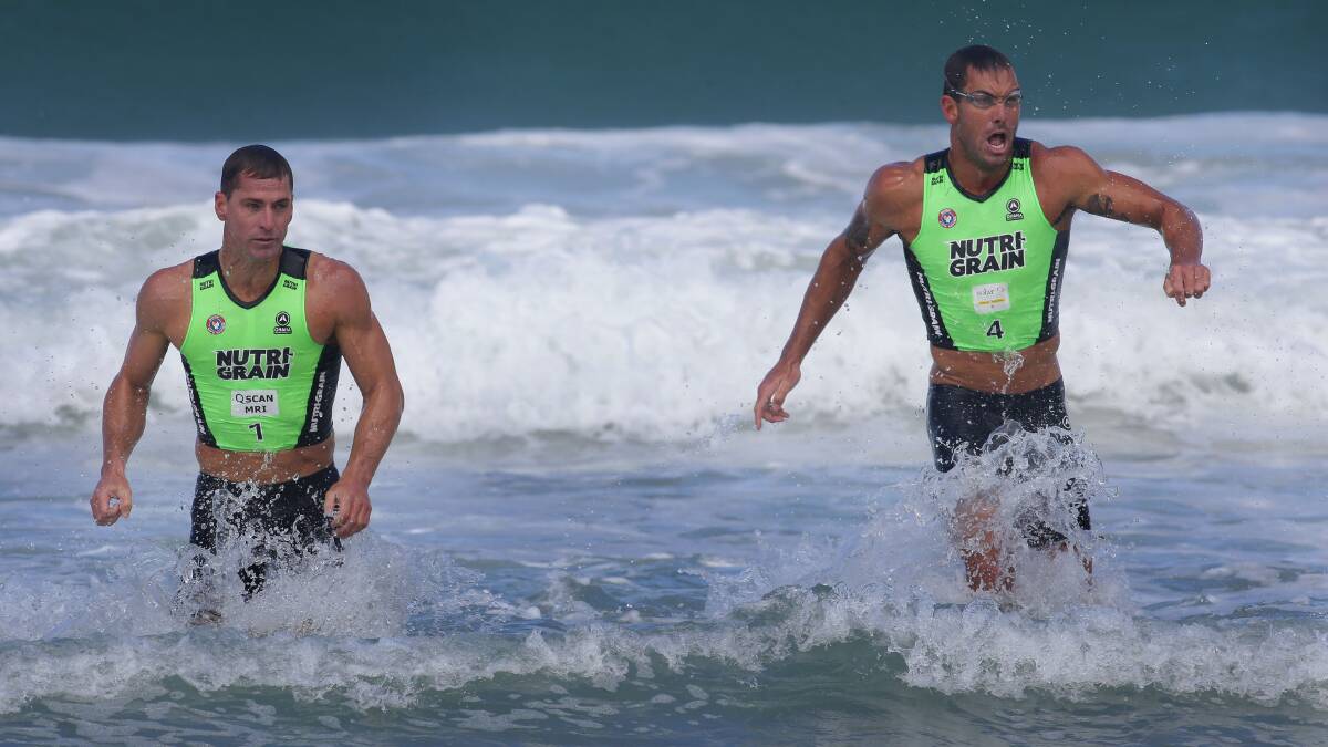 Two standing;Poole and Eckstein shoulder to shoulder in the swim leg.Picture John Veage