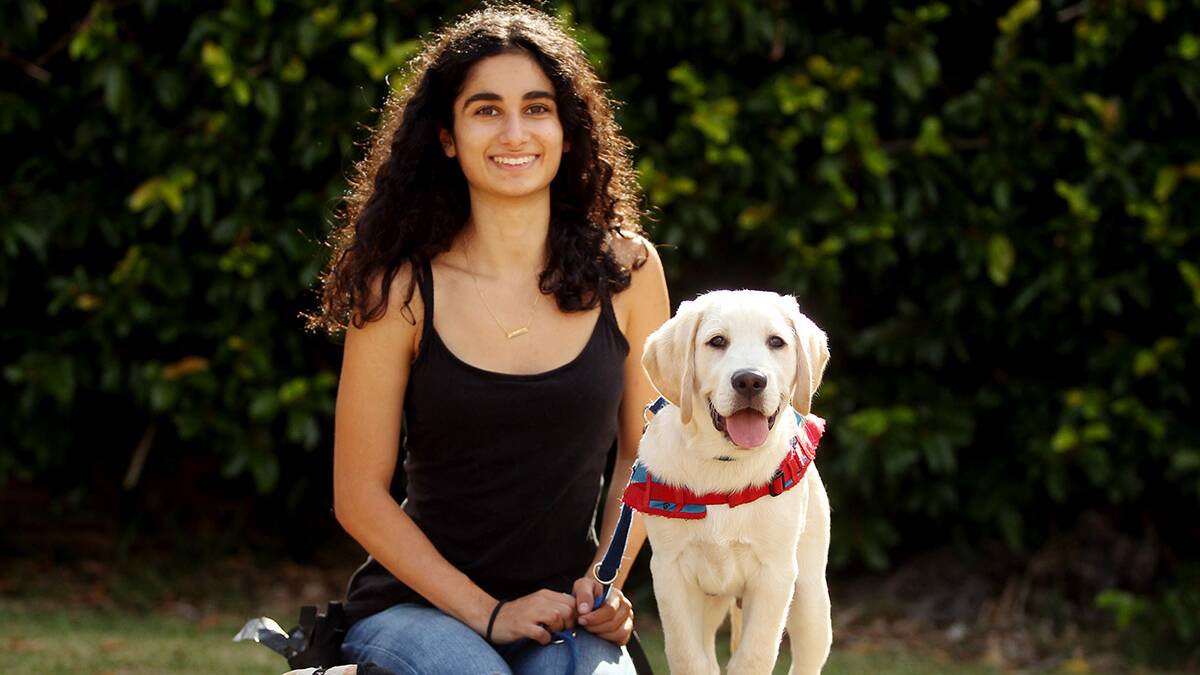 Joy: First time puppy Educator Gaby Khouri with her Assistance Dog. Picture: Chris lane