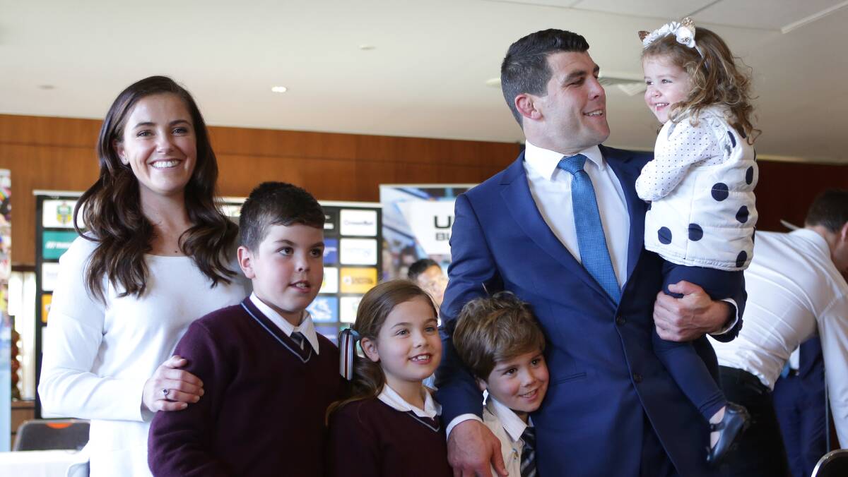 Family first: Michael Ennis with his wife and children at the announcement. Picture: John Veage