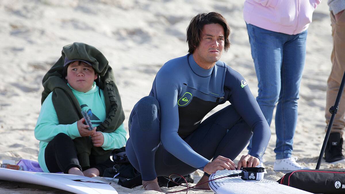 Connor wax's up-helping out at the NSW Surfing regional session at Wanda.Picture John Veage