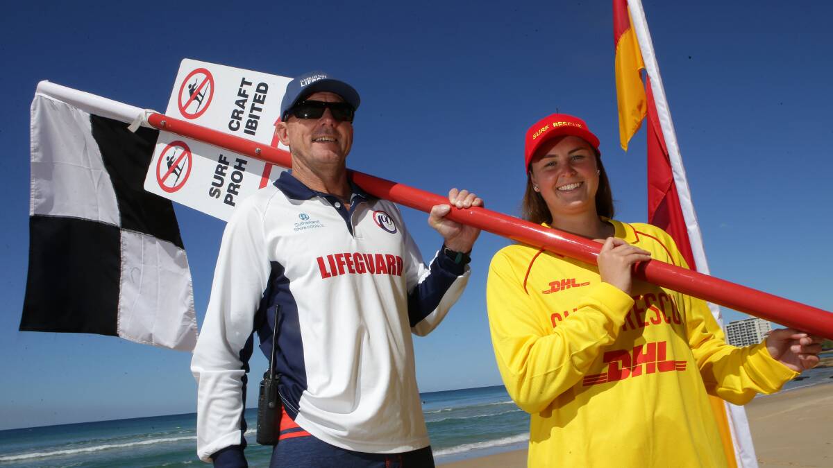 Check: Lifeguard Supervisor Carl Van Zino and lifesaver Alex Budd with the new surfcraft sign on Nth Cronulla Beach. Picture: John Veage