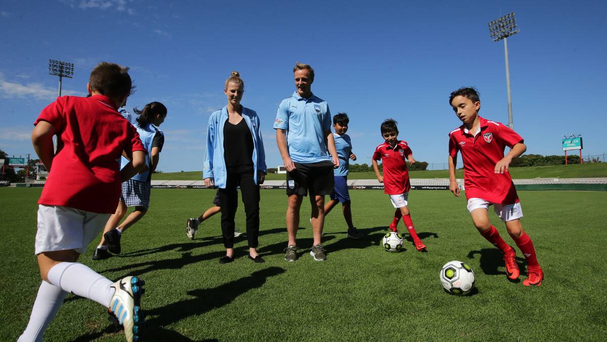 New home: Sydney FC players Ally Green (left) and Rhyan Grant with St George juniors at Jubilee Oval last month. Pictures: John Veage