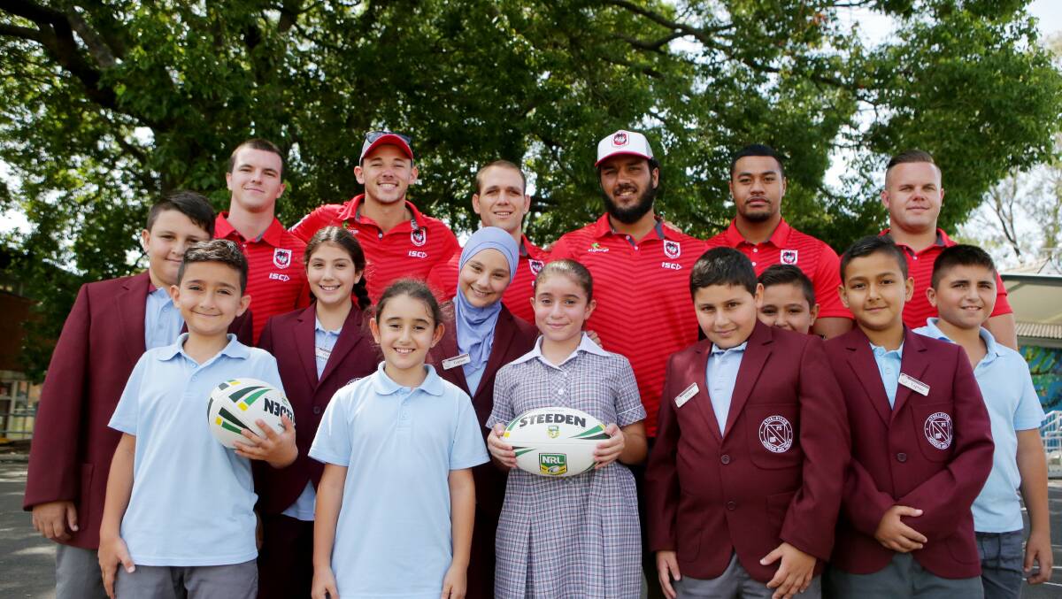 Community visits: St George Illawarra Dragons players and students from Athelstane Public School, Arncliffe on Thursday. Picture: Chris Lane