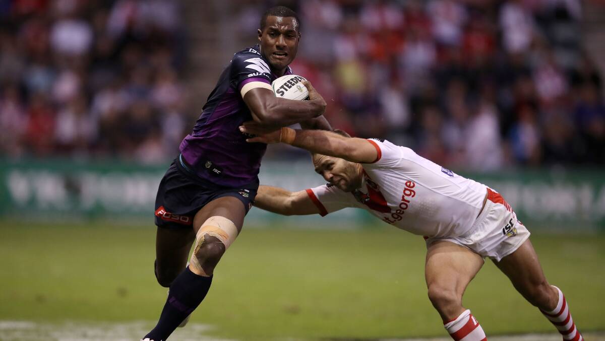 Try time: Melbourne's Suliasi Vunivalu gets around Jason Nightingale to set up a try for Billy Slater. The Storm winger scored two tries of his own. Picture: Mark Kolbe/Getty Images