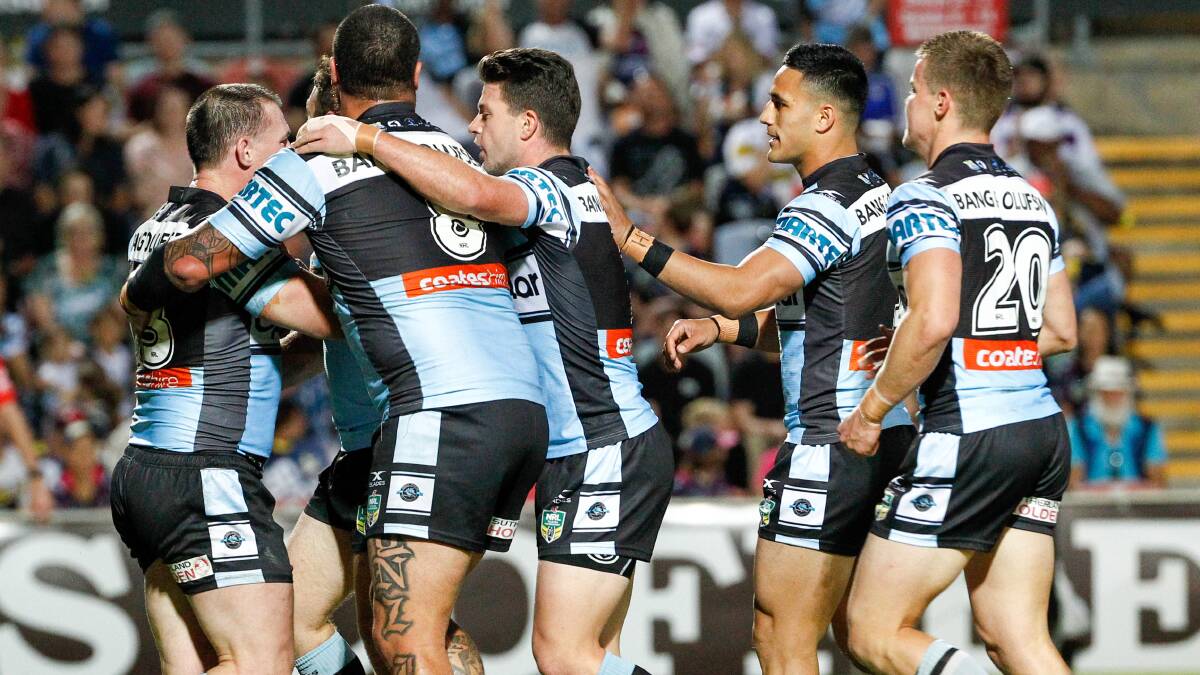 Lining up: Sharks players congratulate captain Paul Gallen on his try against the Cowboys. Picture: Michael Chambers/AAP Image