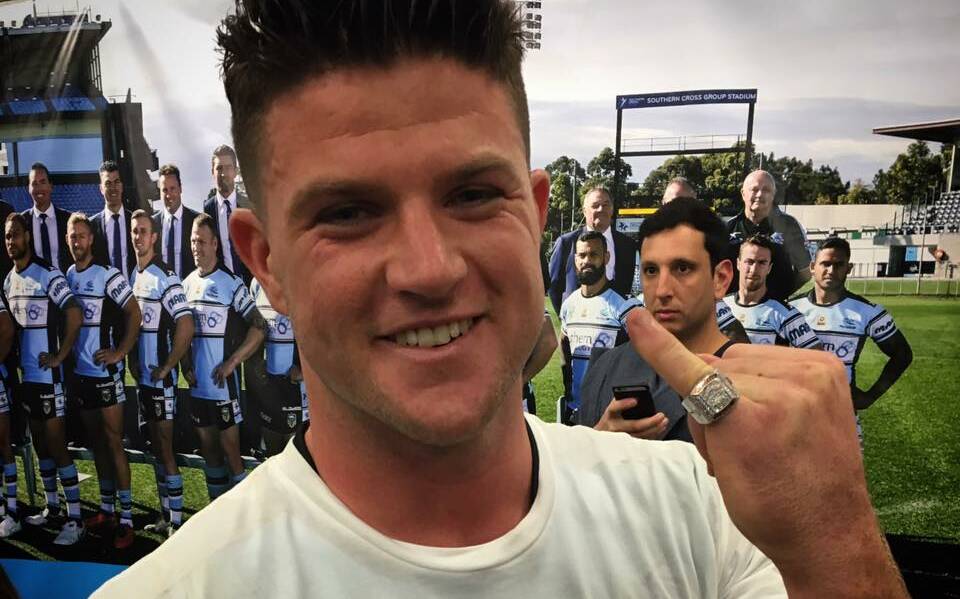 The prize: Chad Townsend showing off his premiership ring in the sheds after the game. Picture: Andrew Parkinson