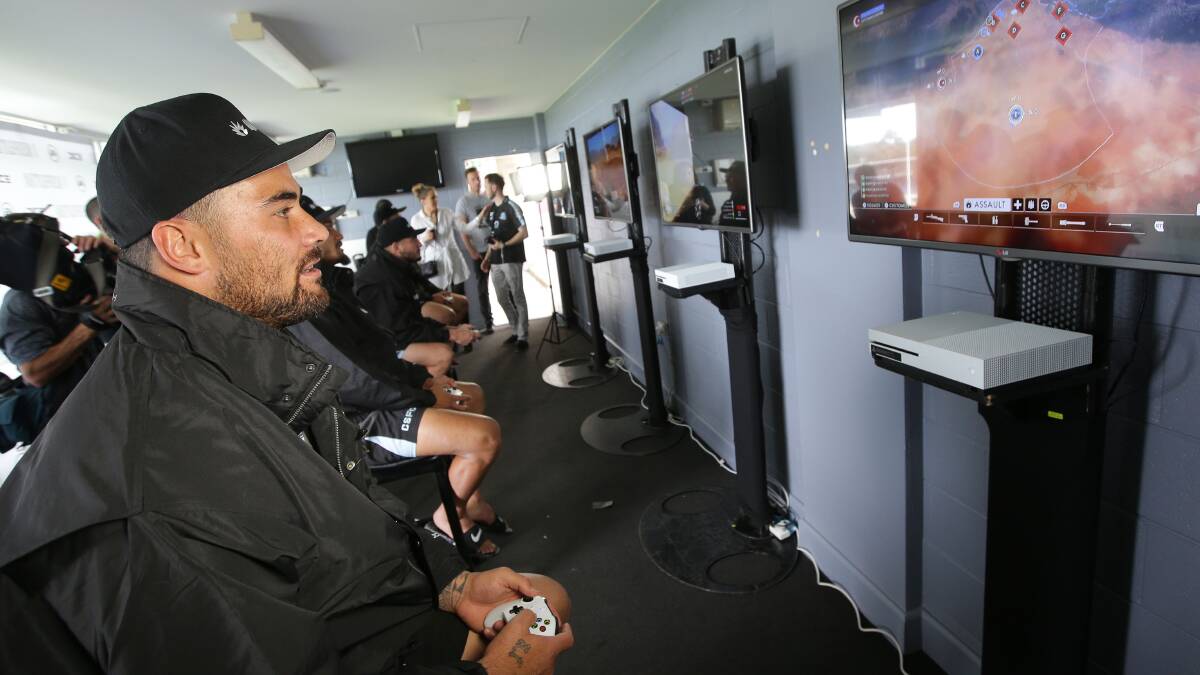 In the game: Sharks prop Andrew Fifita takes on Battlefield 1. Picture: John Veage