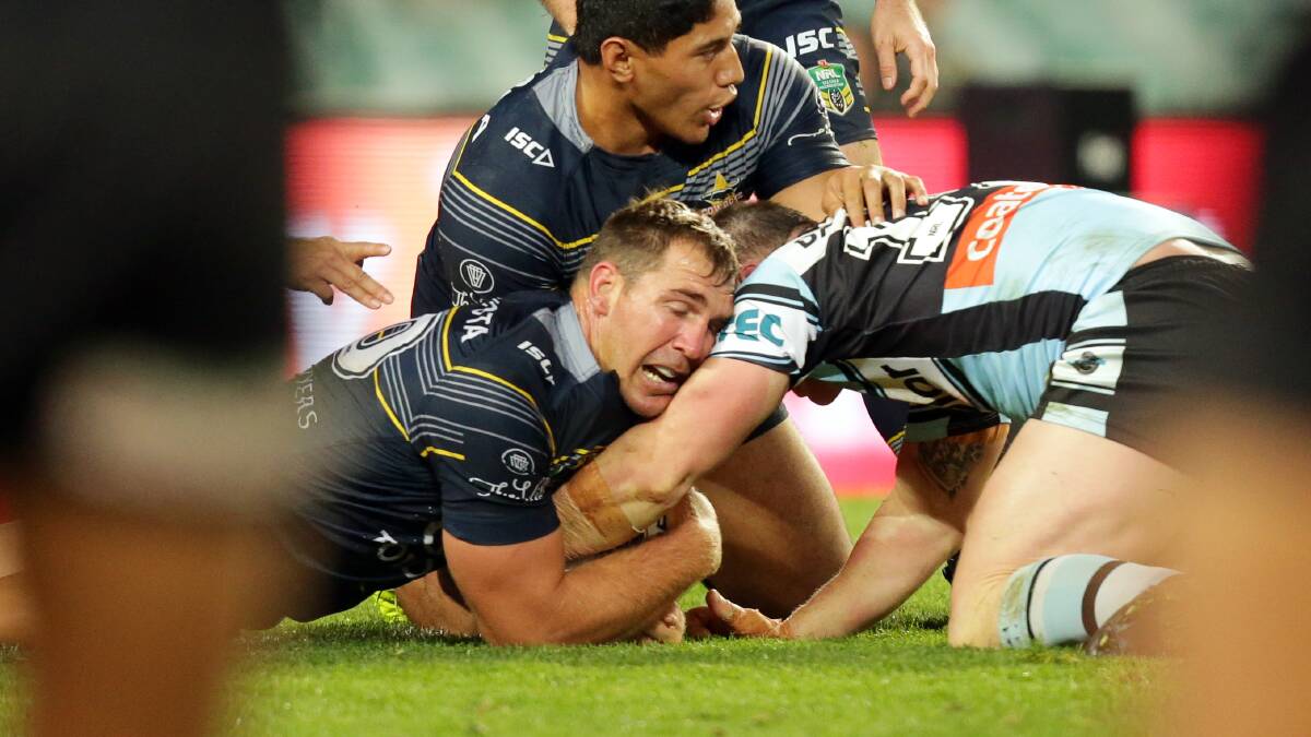 Cowboys defenders appear to have their hands on the ball as Gallen tries to get up. Picture: Chris Lane