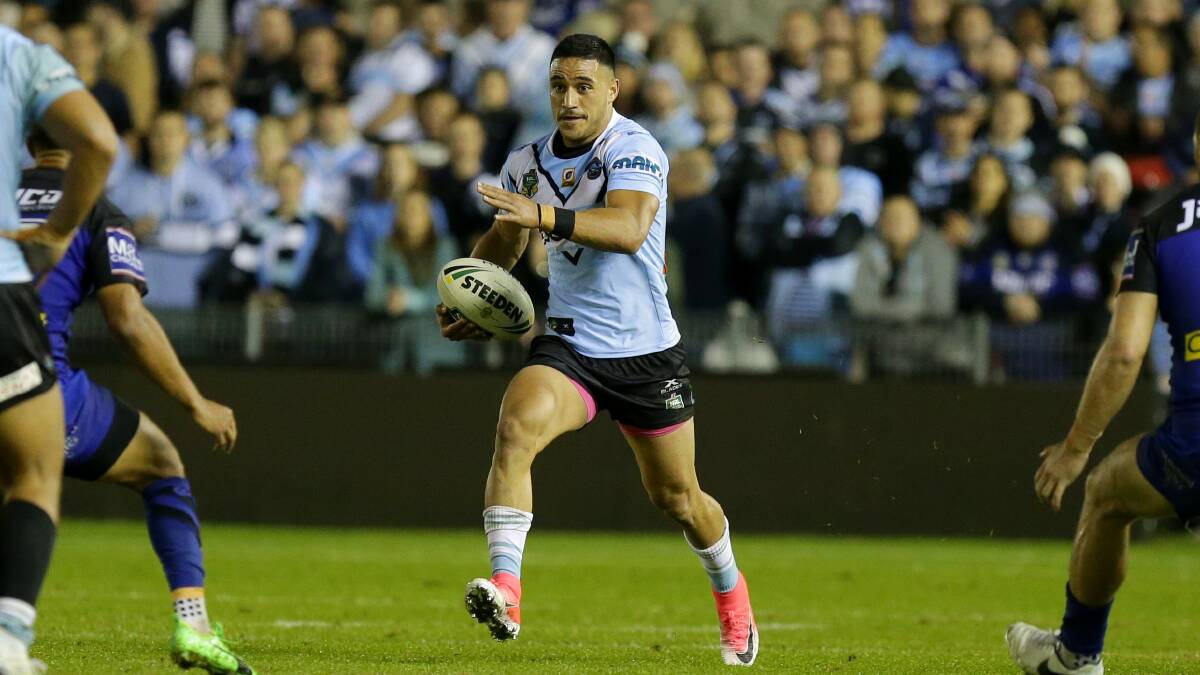 Full steam ahead: Sharks fullback Valentine Holmes with his charge that helped turn the game on Saturday night. Holmes was overlooked by Queensland for Origin I. Picture: Chris Lane