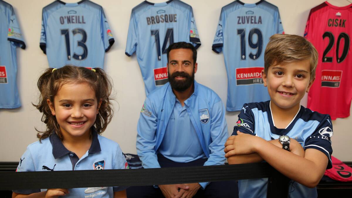 Big blue smiles: Sydney FC captain Alex Brosque with Xavier, 7, and sister Francesca, 6, at Jubilee Oval. Picture: John Veage