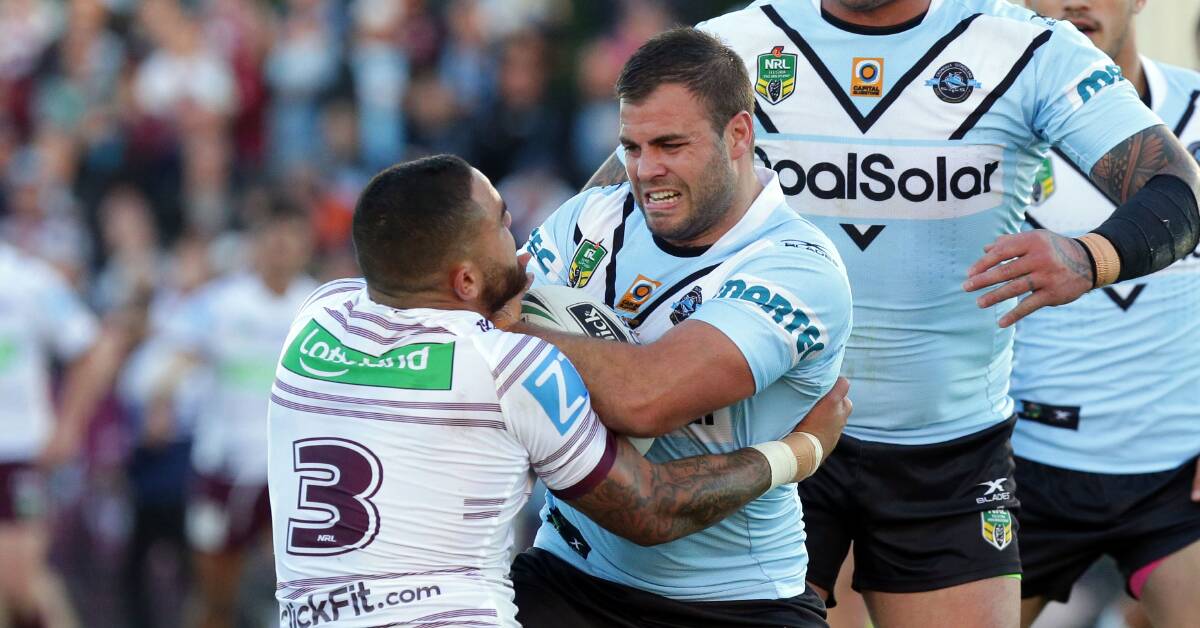 Tough day at the office: Sharks forward Wade Graham is wrapped up by Dylan Walker. Picture: Chris Lane