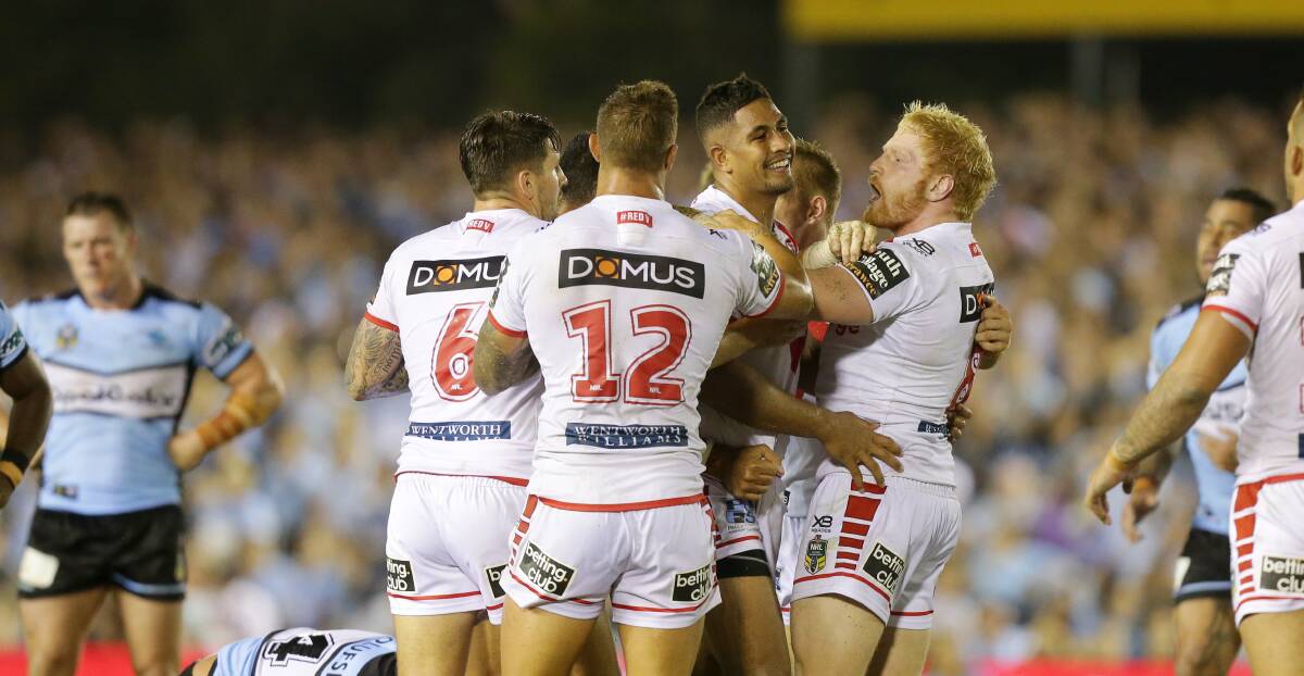 Winners: St George Illawarra players celebrate after the Dragons downed Cronulla 20-16 on Thursday night. Picture: Chris Lane