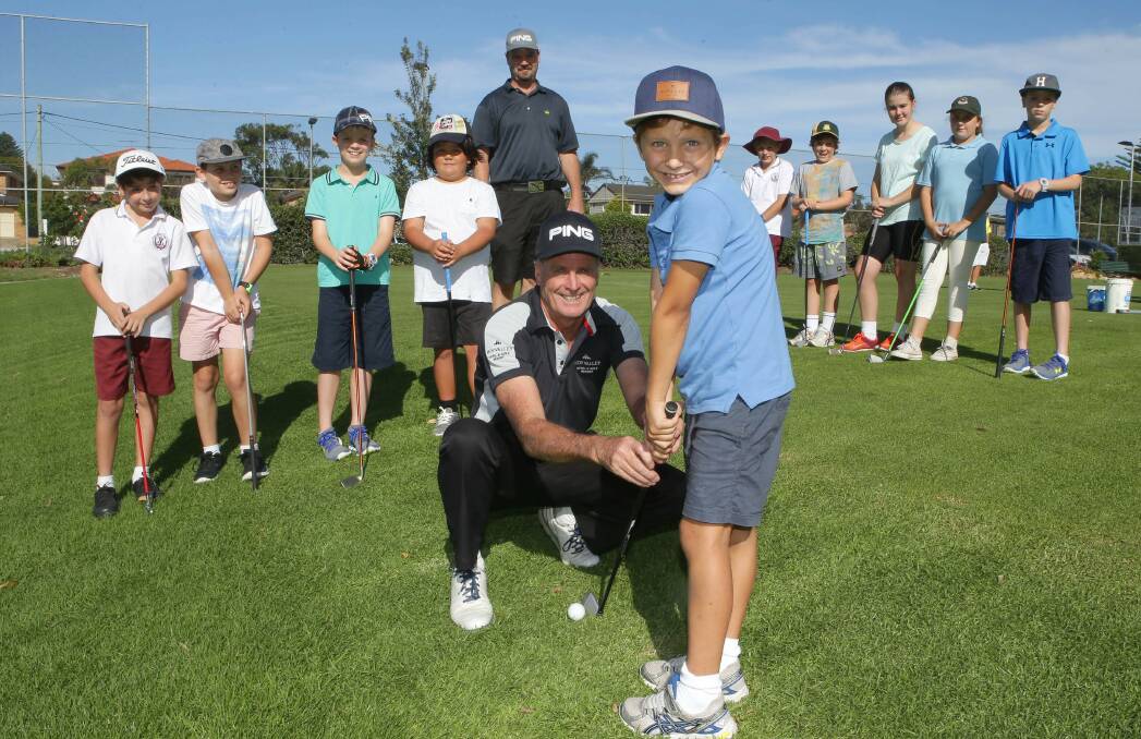 Future masters: Cronulla Golf Club professionals Col Arnold (front) and Warwick Dews (back) with players from the club's junior clinic. Picture: John Veage