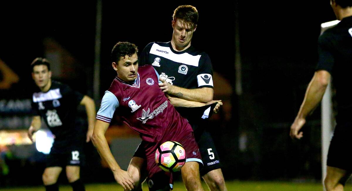 Getting tight: Sutherland captain Nick Littler attempts to win the ball against APIA Leichhardt on Saturday night. Picture: Jeremy Ng/Football NSW
