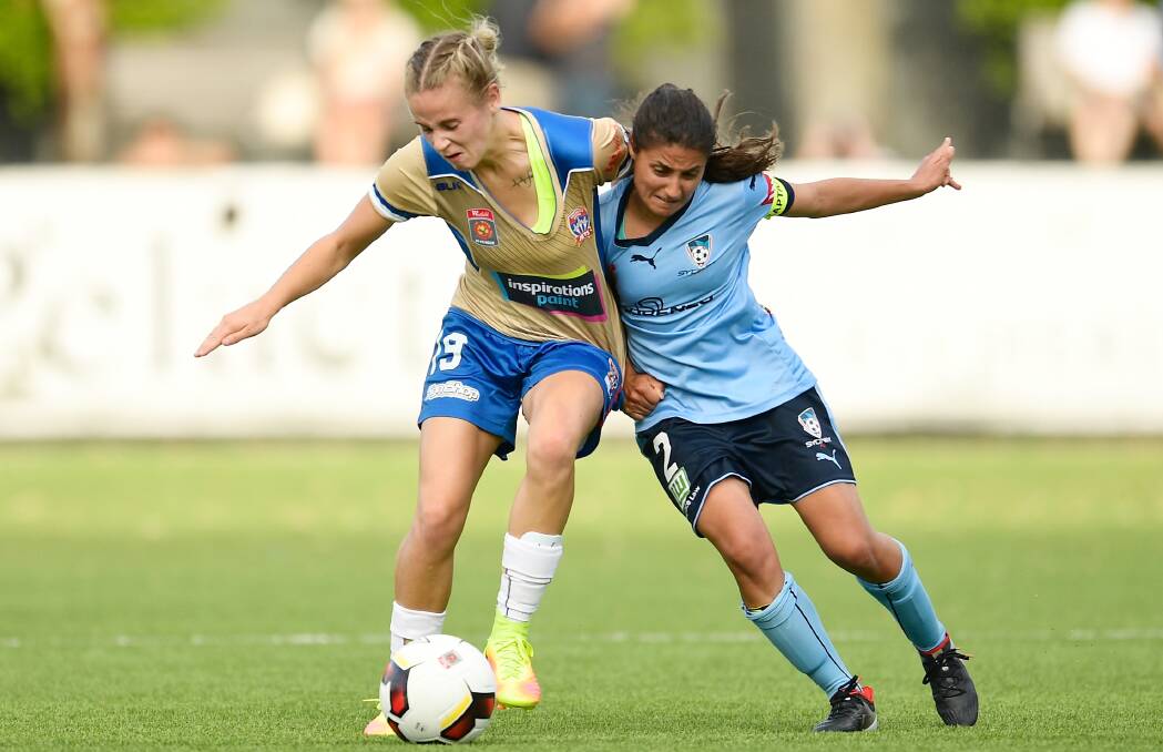 Still battling: Teresa Polias (right) challenges Newcastle Jets' Ashlee Brodigan in her 100th W-League game on Saturday. Picture: Brett Hemmings/Getty Images