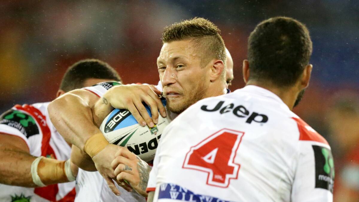 Swapping colours: Knights forward Tariq Sims (centre) will join the Dragons. Picture: Jonathan Carroll