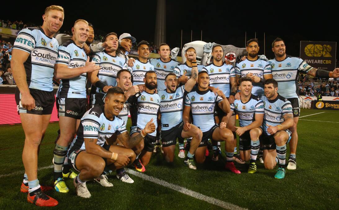 Lapping it up: Cronulla players celebrate their qualifying final victory over Canberra in front of their travelling fans on Saturday night. The win earned the Sharks a much needed week off. Picture: Getty Images