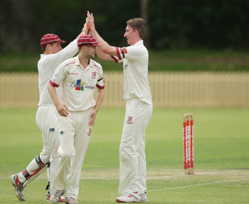 Got him: St George wicketkeeper Jonathan Rose congratulates Eric Denhartog on another wicket on Saturday. Picture: Chris Lane