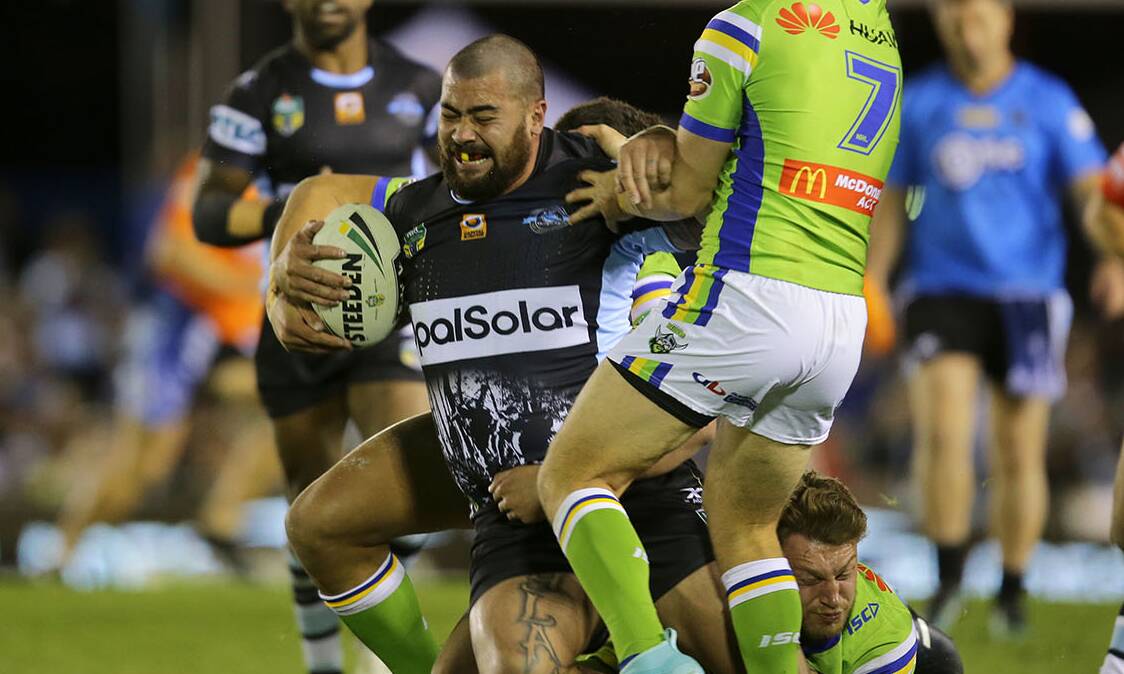 Stopped in his tracks: Sharks prop Andrew Fifita is tackled by three Raiders defenders on Saturday night. Picture: John Veage
