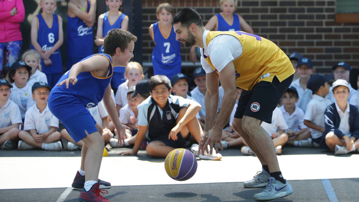 King of the kids: Sydney Kings captain Kevin Lisch takes on the St Aloysuis Primary School, Cronulla basketball team last week. Picture: John Veage