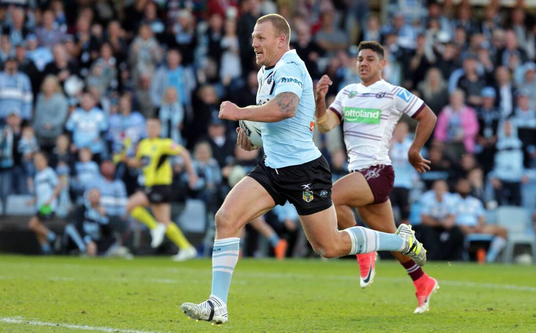 The hunted: Luke Lewis scores an intercept try against Manly on Sunday. Picture: Chris Lane