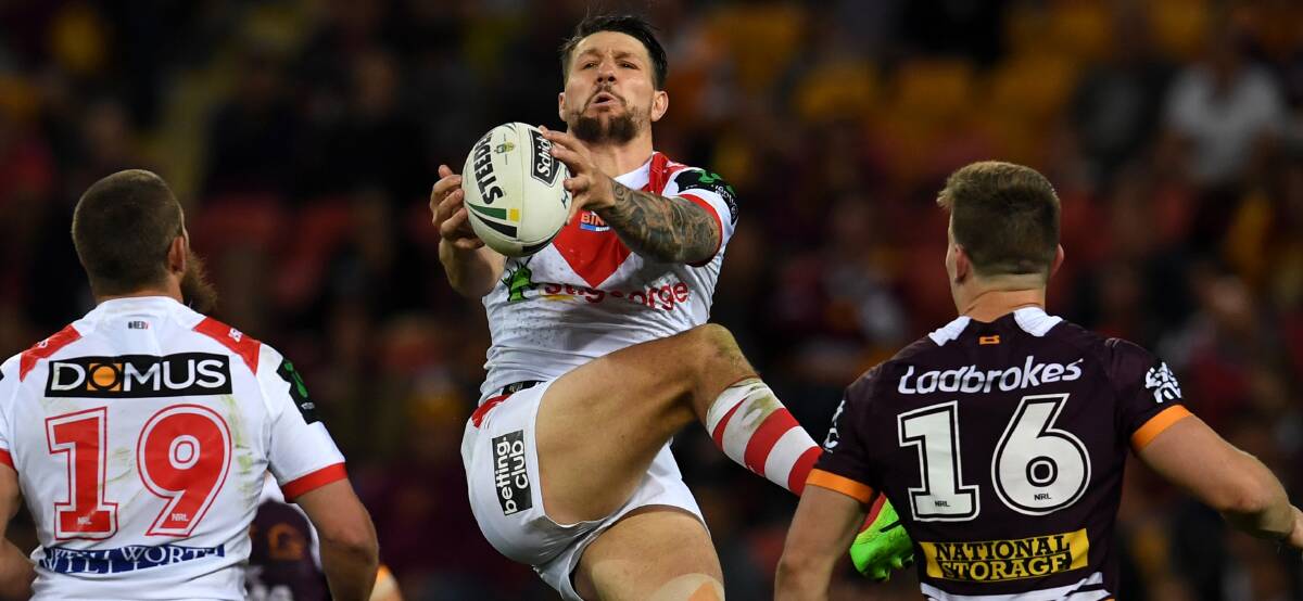 In their hands: Dragons captain Gareth Widdop catches a high kick against Brisbane on Friday night. Picture: Dan Peled/AAP Image