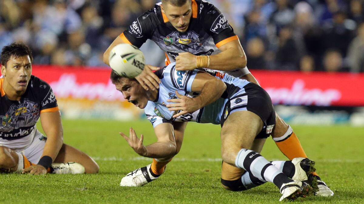 First impression: Daniel Mortimer evades a tackle against the Tigers. Picture: Chris Lane