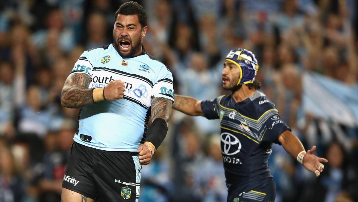 Highs and lows: Sharks prop Andrew Fifita celebrates in the 2016 preliminary final as Johnathan Thurston looks on. Picture: Mark Kolbe/Getty Images