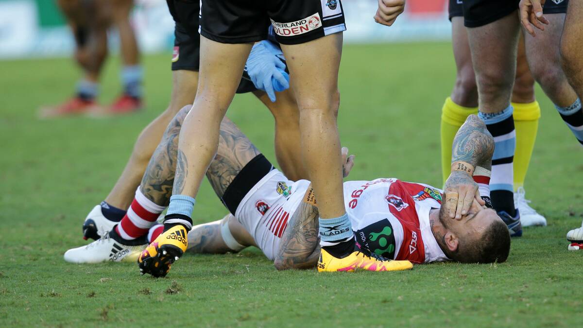 Down: Dragons fullback Josh Dugan holds his face. Picture: John Veage