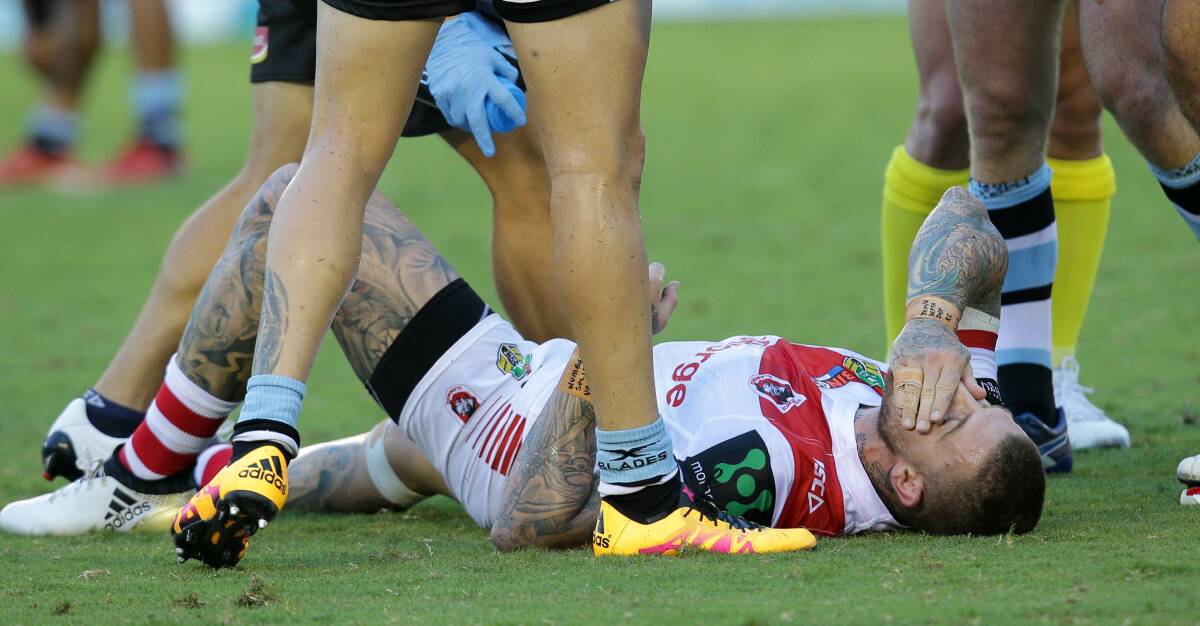 Down: Dragons fullback Josh Dugan holds his face. Picture: John Veage
