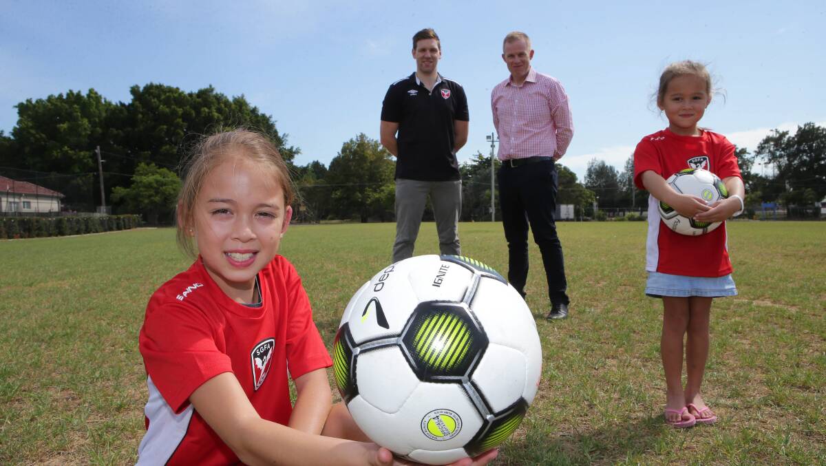 New home: St George Football Association juniors Olivia and Isabelle with SGFA operations coordinator Daniel Thistleton (left) and general manager Craig Kiely at the Ador Avenue ground on Monday. Picture: John Veage