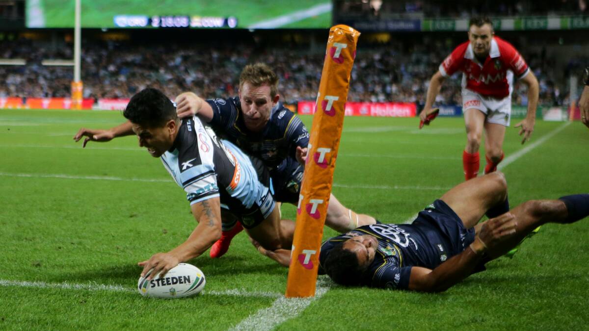 Try time: Sharks winger Sosaia Feki scores the opening try. Picture: John Veage