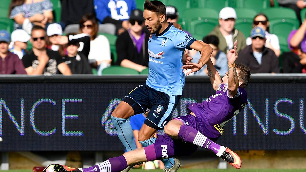 On the ball: Milos Ninkovic rides a challenge against Perth Glory on Sunday night. Picture: Stefan Gosatti/Getty Images