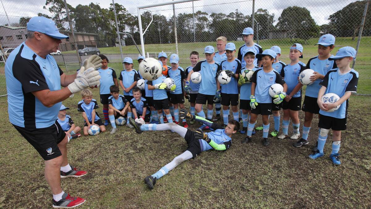 In good hands: Sutherland Shire Football Association goalkeeper coach Ron Tilsed (left) with Loftus goalkeeper Jack Doran at the Sydney FC holiday clinic at Kareela. Picture: John Veage