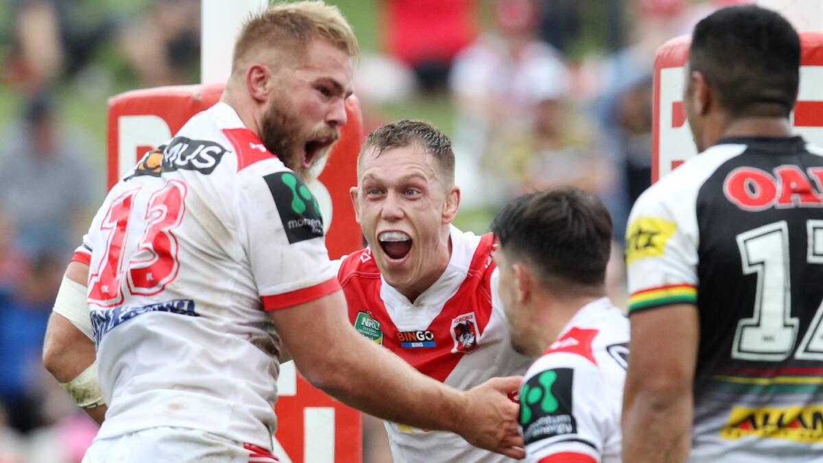 Celebration: Dragons forward Jack de Belin is congratulated on his solo try. Picture: Chris Lane