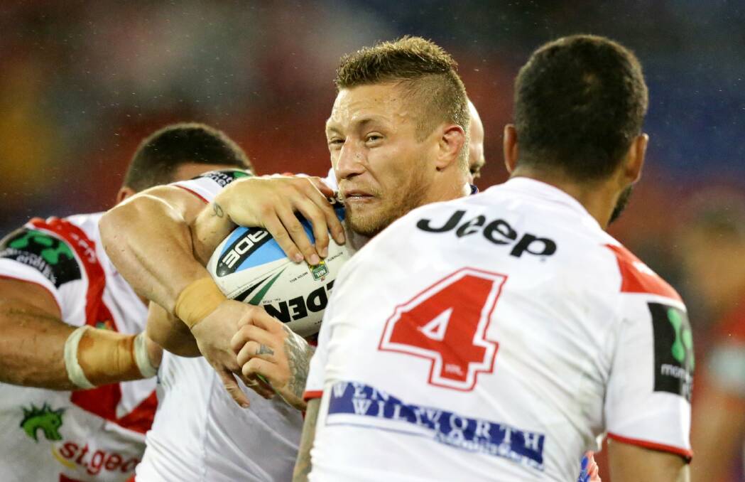 New colours: Tariq Sims (centre) has joined St George Illawarra after leaving Newcastle. The Dragons play the Knights on Saturday. Picture: Jonathan Carroll