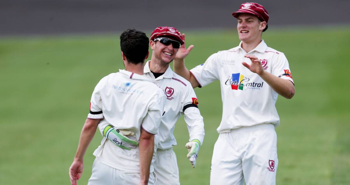 Happy days: St George wicketkeeper Jonathan Rose congratulates Nick Stapleton on one of his three wickets. Picture: Chris Lane